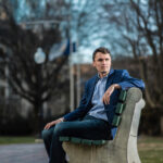 Patriot Charlie Kirk Sitting on a bench for a portrait. RIP Charlie Kirk