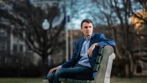 Patriot Charlie Kirk Sitting on a bench for a portrait. RIP Charlie Kirk