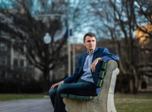 Patriot Charlie Kirk Sitting on a bench for a portrait. RIP Charlie Kirk